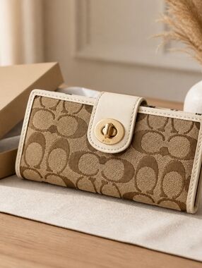 Coach Signature Slim Envelope Wallet featuring a khaki brown monogram canvas